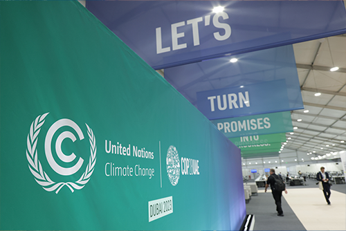 Sovereign ESG Update – Setbacks in a tumultuous world main image - Banners at COP28 UNFCCC